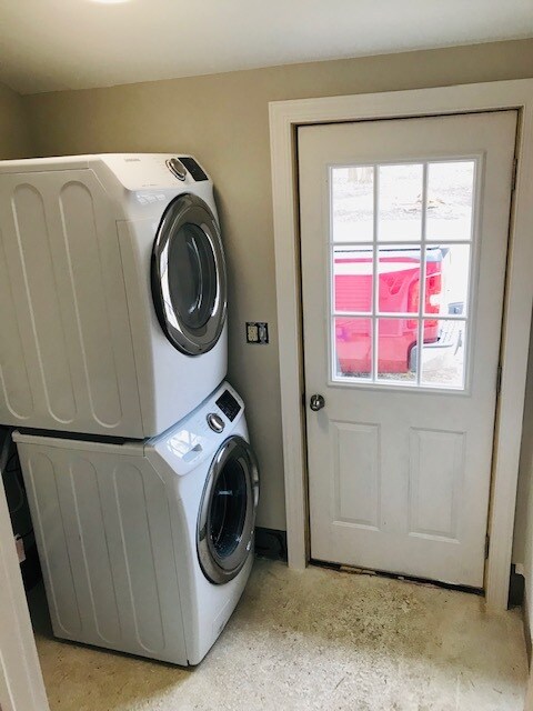 Laundry room featuring stackable washer and dryer. Also featuring a utility sink. - 9372 E Miami Ave