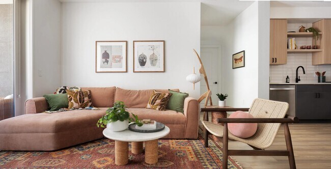 Open-concept living with warm wood finishes, stainless steel appliances, and a seamless flow from kitchen to lounge—designed for everyday ease. - Modera Rio Salado