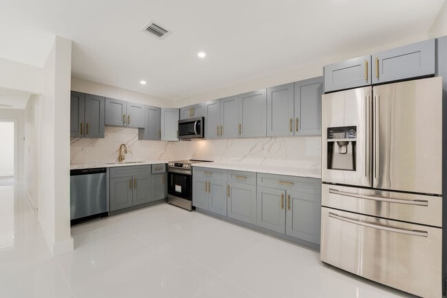 Photo - Fully renovated stylish 3 bed 2 bath home featuring a luxury kitchen, modern appliances on a fenc...