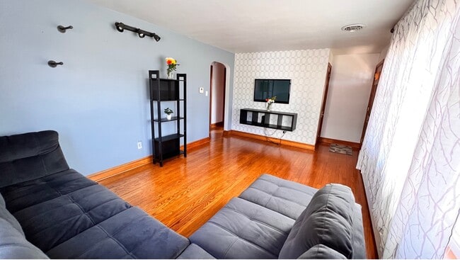 Sala de estar con sofá grande y televisor. - 324 Woodland View Dr Unidad Whole House