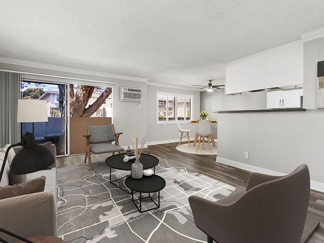 Hardwood floored living room with view of dining area.