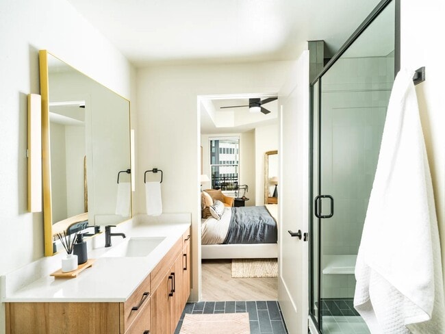 Bright and airy baths at Modera St. Paul feature sleek finishes and spacious layouts, seamlessly connecting to your restful bedroom retreat in Dallas.