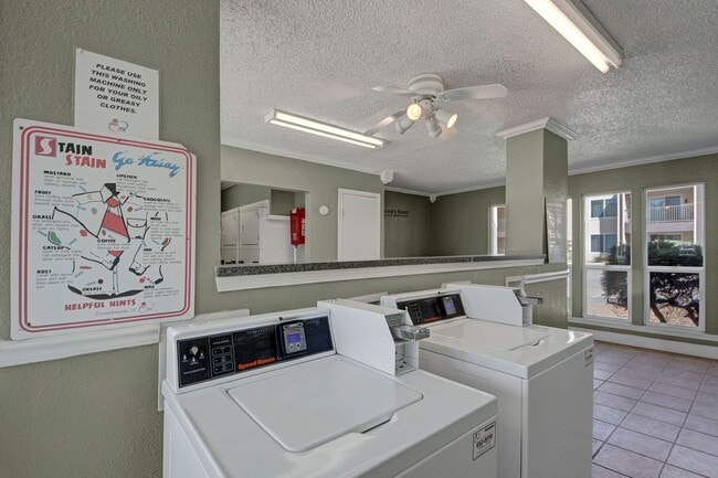 The shared laundry room with multiple washers and dryers for resident use - Fairgreen