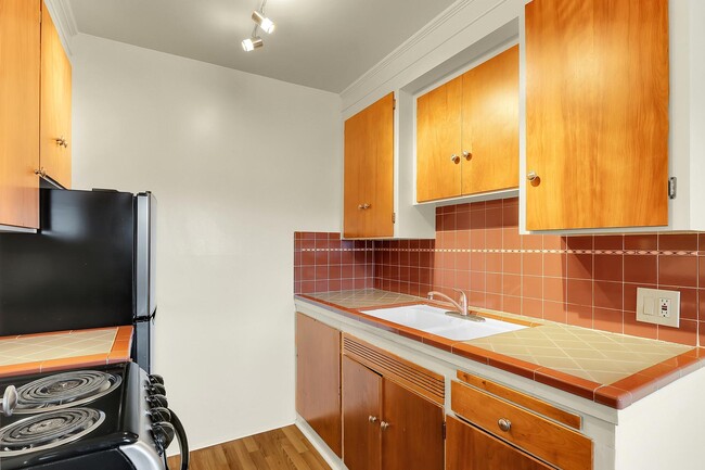 Awesome kitchen with tile counters - Birch Tree Apartments Unit 7