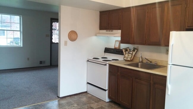 Kitchens come equipped with stove and refrigerator.
