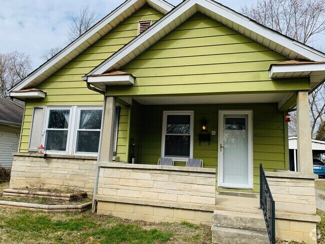 Covered front porch with raised garden beds under the bedroom window. - 211 E Vermilya Ave Rental