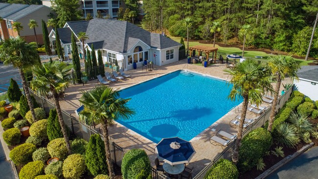 Bask in sun-soaked serenity by our expansive resort-style pool with a sprawling sundeck. - The Legends at Lake Murray Apartments