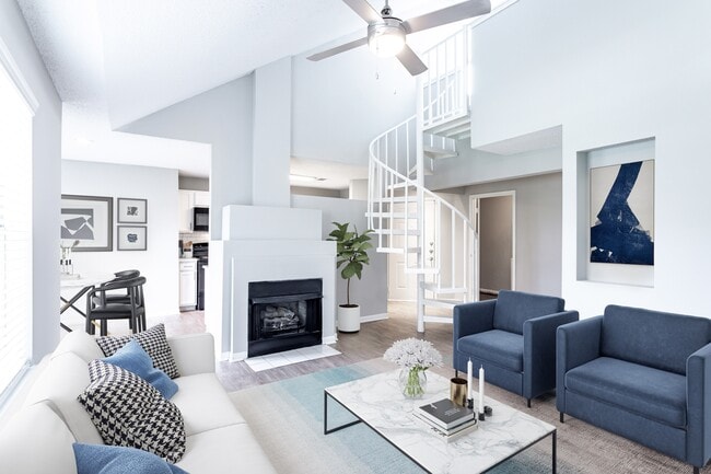 Sophisticated living room with a fire place and spiral loft stairs - Avana Lexington Apartments