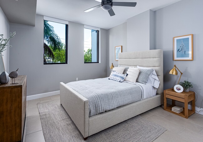Spacious bedroom with hard surface flooring and ceiling fan