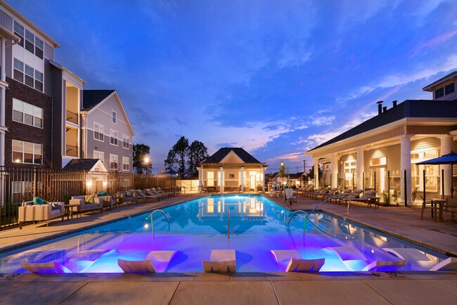 Swimming pool and sundeck with lounge seating - Avalon Laurel Apartments