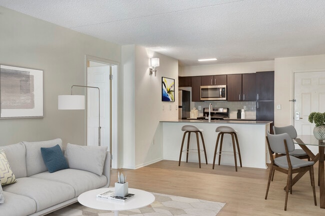 Renovated Package II kitchen, living, and dining areas with hard surface plank flooring