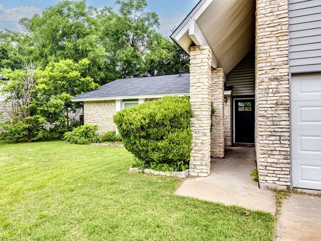Photo - Charming 4BR / 2BA Home Featuring Fireplace, White Cabinets & Big Tree