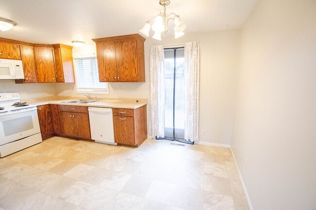 Photo - Ranch-style home with great fenced yard & patio!