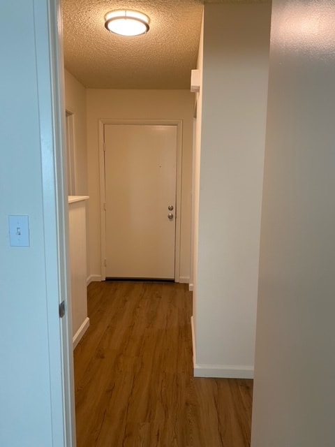 Entry way has wood like flooring and a ledge for all your stuff to drop when coming home