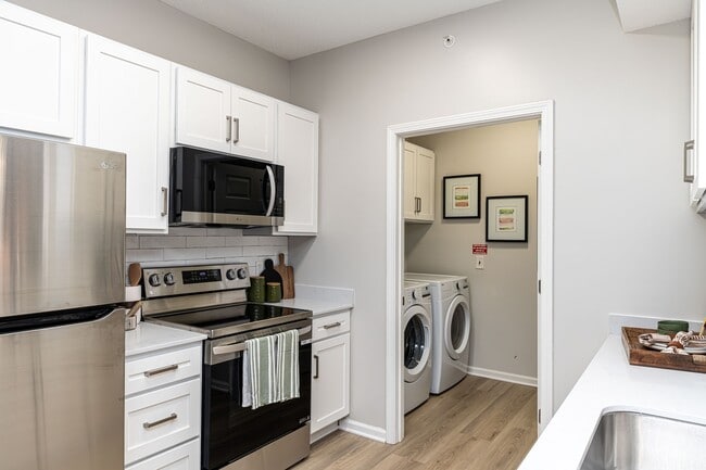 Kitchen & laundry room with hardwood-style flooring
