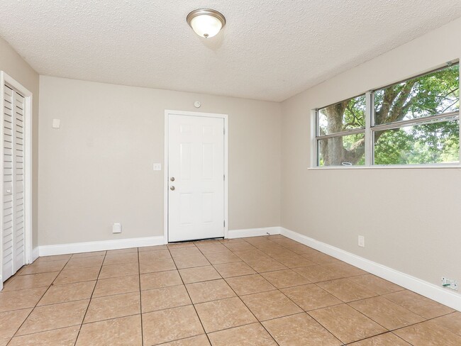 Photo - 3 BR/1BA | Newly Renovated Single Family Home | Screened in Patio and carpot | Huge backyard!