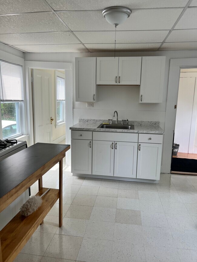 kitchen with all white cabinets and gas stove - 103 Pleasant St Unit 1