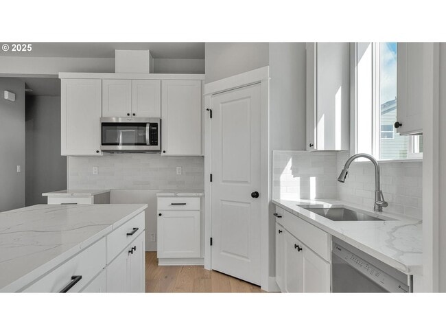 Photo - Newly Built Modern Open-Concept Condo with Island Kitchen, Granite Counters and a Deck