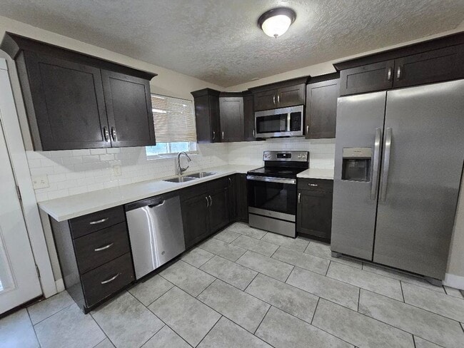 Building Photo - Spacious 5-Bedroom Magna Home with Deck and Ample Parking