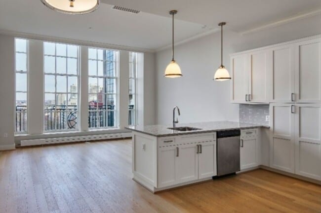 Open living spaces with high ceilings & expansive windows