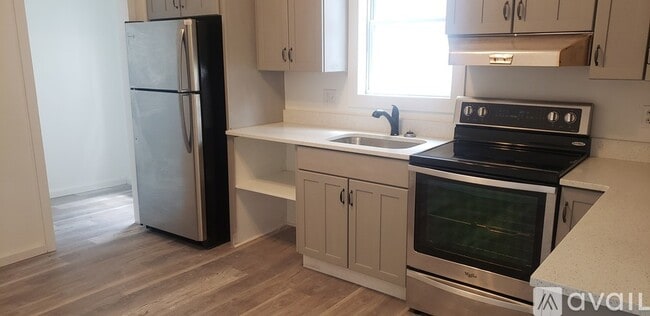 Kitchen with stainless steel fridge and stove - 335 1st St Unit 1