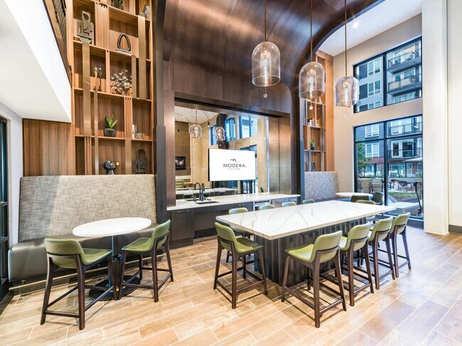 Community dining space with a shared island, arched wood ceiling, and bar seating designed for hosting, casual meals, and welcoming guests.