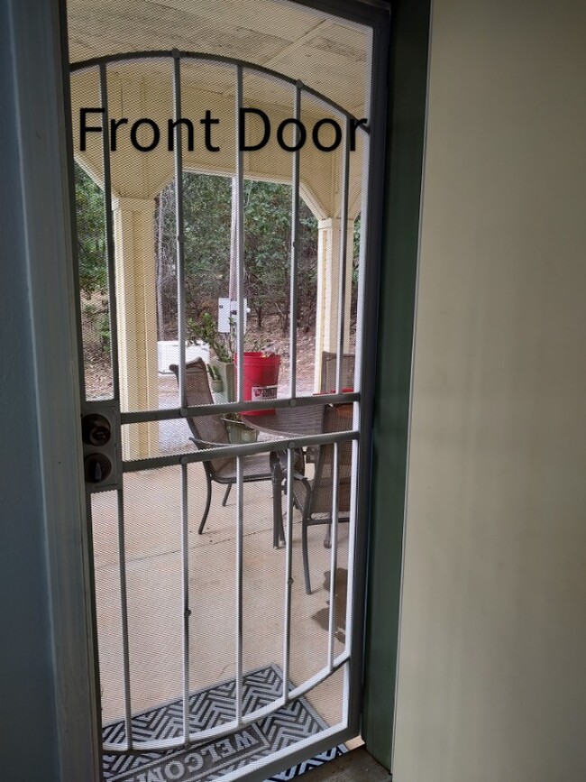 Main entrance showing Covered patio w table and chairs - 6588 Log Cabin Ln Unit Apartment