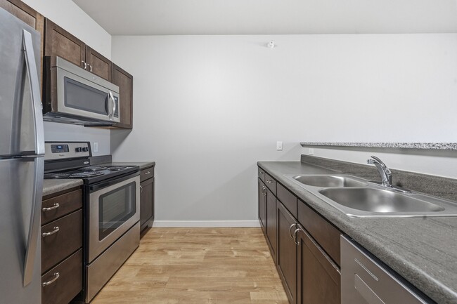 Step into the modern kitchen at North Highlands Apartments, featuring sleek stainless steel appliances, ample counter space, and contemporary cabinetry. Ideal for culinary enthusiasts and everyday living. Schedule your tour today!