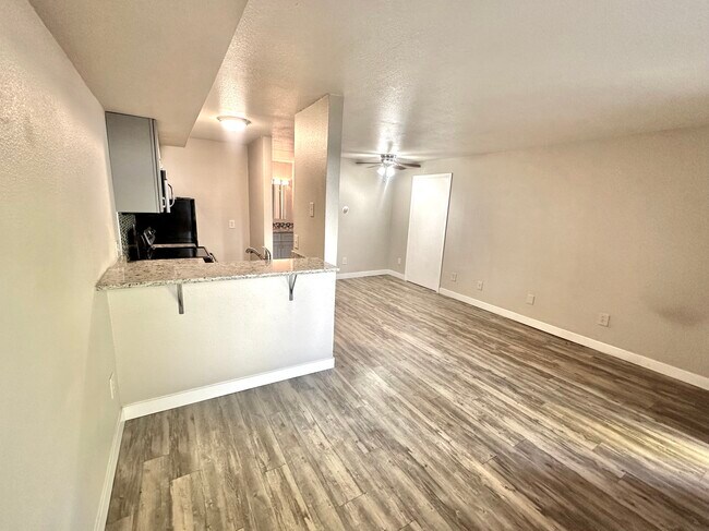 Experience modern living with this sleek and inviting open-concept apartment design. - Apex 980