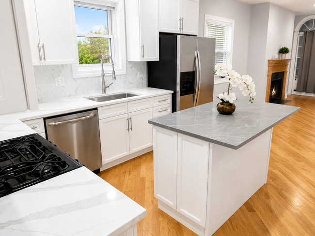 New kitchen with deep sink, backsplash, and quartz countertops - 3513 North Reta Avenue Unit Apt 1