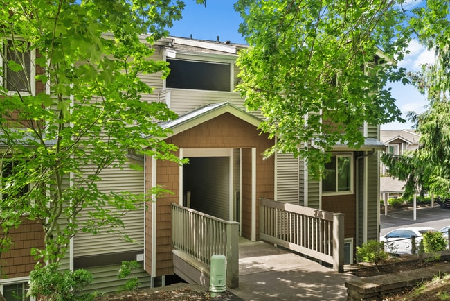 Charming community entrance surrounded by mature greenery. - Terrace on Meridian