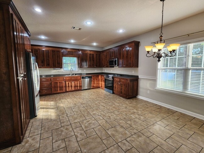 Photo - !!$500!! OFF FIRST MONTH!! Spacious 4BR Home with Fireplace, Screened Porch & Privacy-Fenced Yard