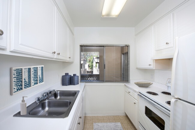 Classic kitchen with white cabinetry and white appliances