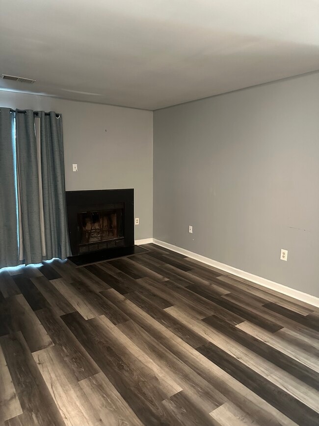 Living room with wood-burning fireplace - 5384 Bedford Ter Unit Clusters at Woodlawn