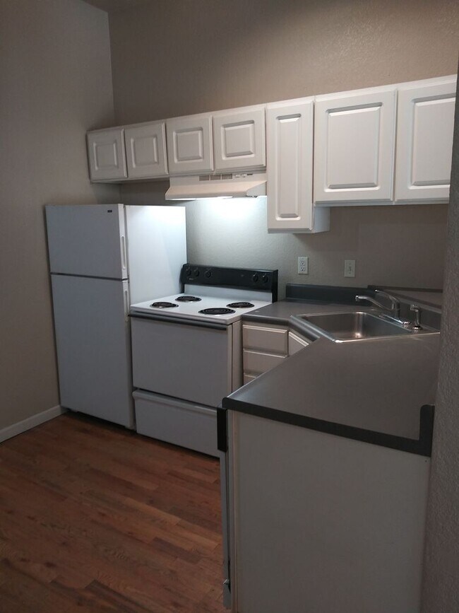 Photo - Large windows and exposed brick wall Unit 305
