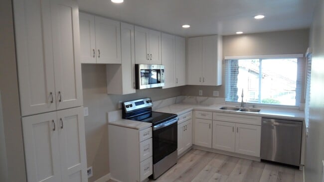 Photo - REMODELED 2BR; 2BA end unit condo with 1 car garage & 1 parking space