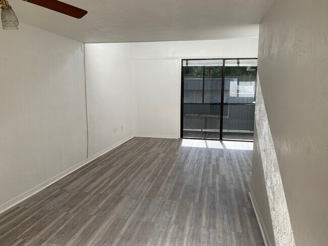 Living/dining rooms with balcony - 609 SW 75th St Unit 201