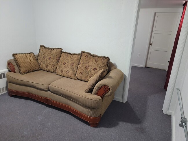 Living room with couch and view into bedroom - 481 S 100 E Unit In-law/Basement apartment