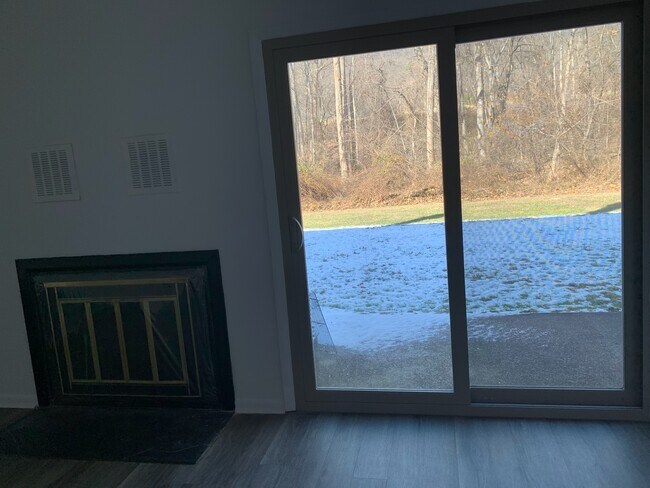 Living room back patio sliding door and wood fireplace - 845 Brian Dr