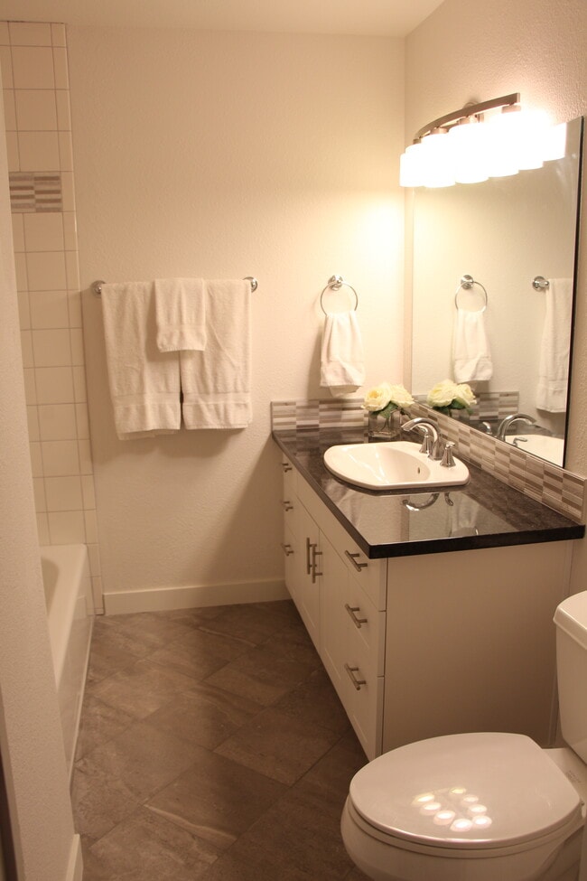 Main bathroom is complete with tile floors and granite counter top - 10418 Northeast 32nd Place Unit C105
