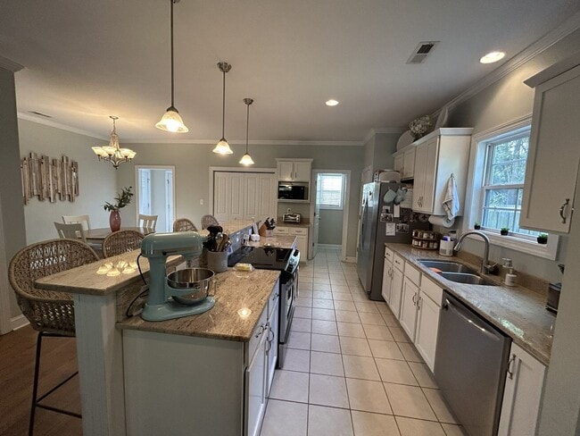 Photo - Enjoy private living in this beautiful 3 bedroom, 2.5 bathroom home on almost half acre lot!