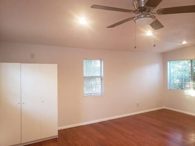 Bright main living area with ceiling fan.
