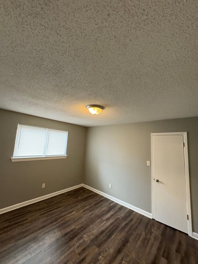 Photo - This 2BR/1BA includes a nice-sized living area, an ample kitchen, a fenced-in