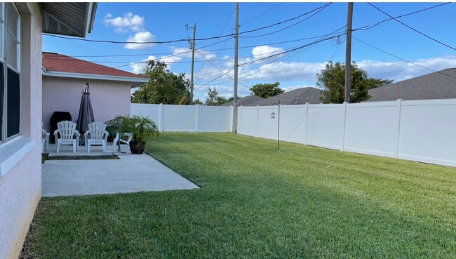 Nice open space in the back yard surrounded by a privacy fence with lock. - 3633 Country Club Blvd Unit 2 - Left Side