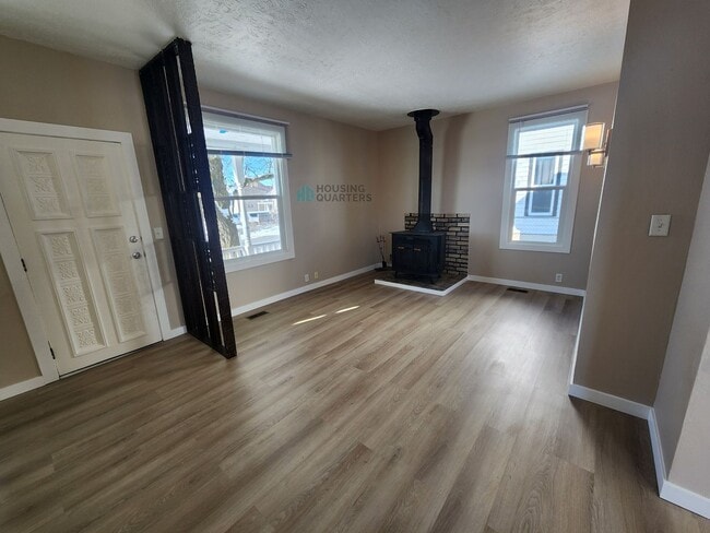 Photo - This 3-bed, 1-bath home features original woodwork, a covered front porch, a fenced yard, and an ...