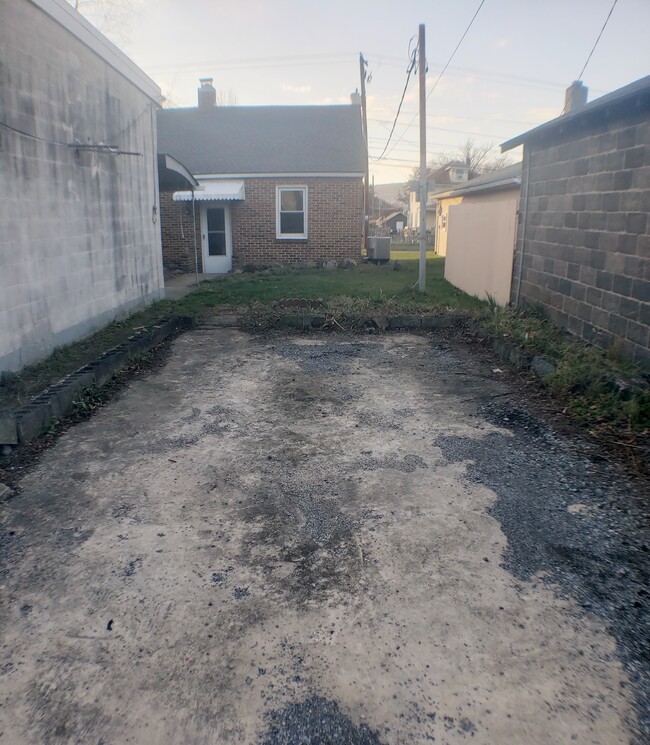 Off Street parking space (Behind House) w/ motion sensor lights (pointing towards parking/path and on the back door) - 3633 N 6th St House