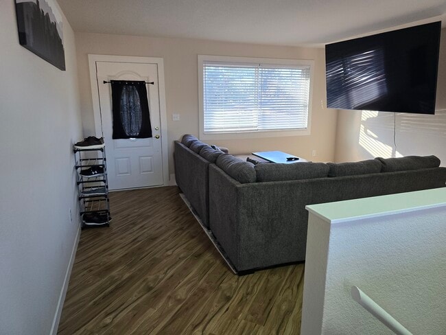 Main living room with 75-inch smart TV. - 902 S Zephyr Ct