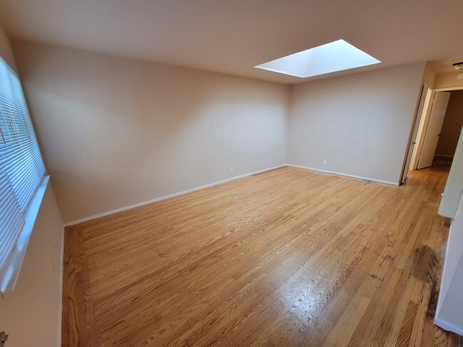 Another angle of the living room with skylight - 2227 Roosevelt Ave Unit 2