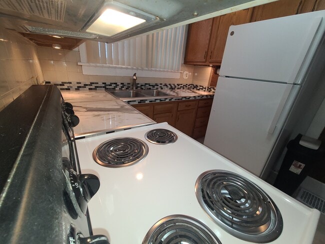 Looking through pass through to kitchen and new quartz countertops - 122 Edgerton Rd Unit Edgerton first floor