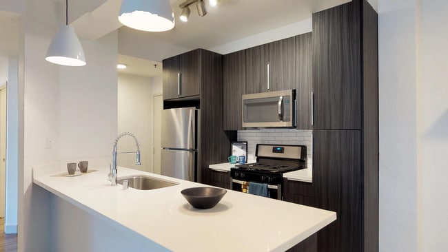 Modern kitchen featuring dual tone cabinetry and large island.